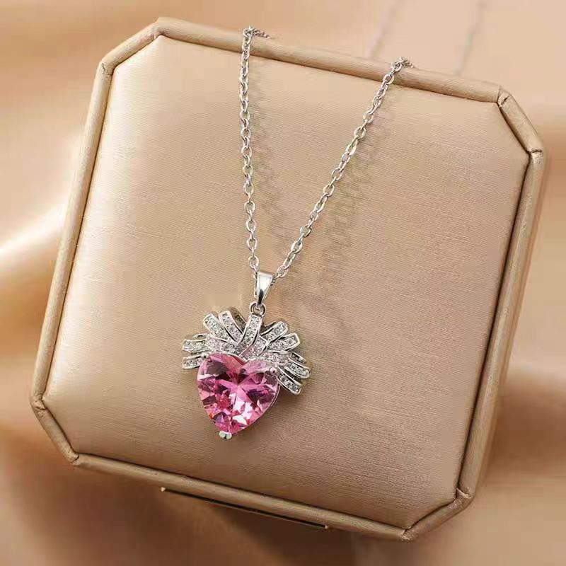 The Lycoris Radiata-inspired children's play series versatile clavicle chain with bow and silk pendant, featuring a heart-shaped zircon and pink diamond design.