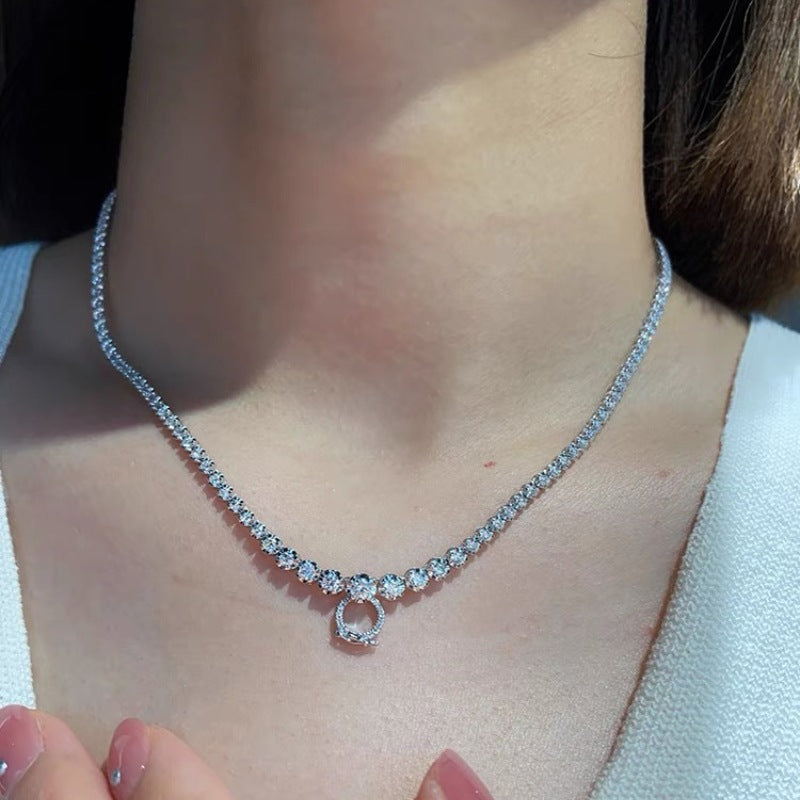 A versatile, high-end necklace with a full diamond clasp and a multi-purpose chain. It features a unique design and a sophisticated, understated style.