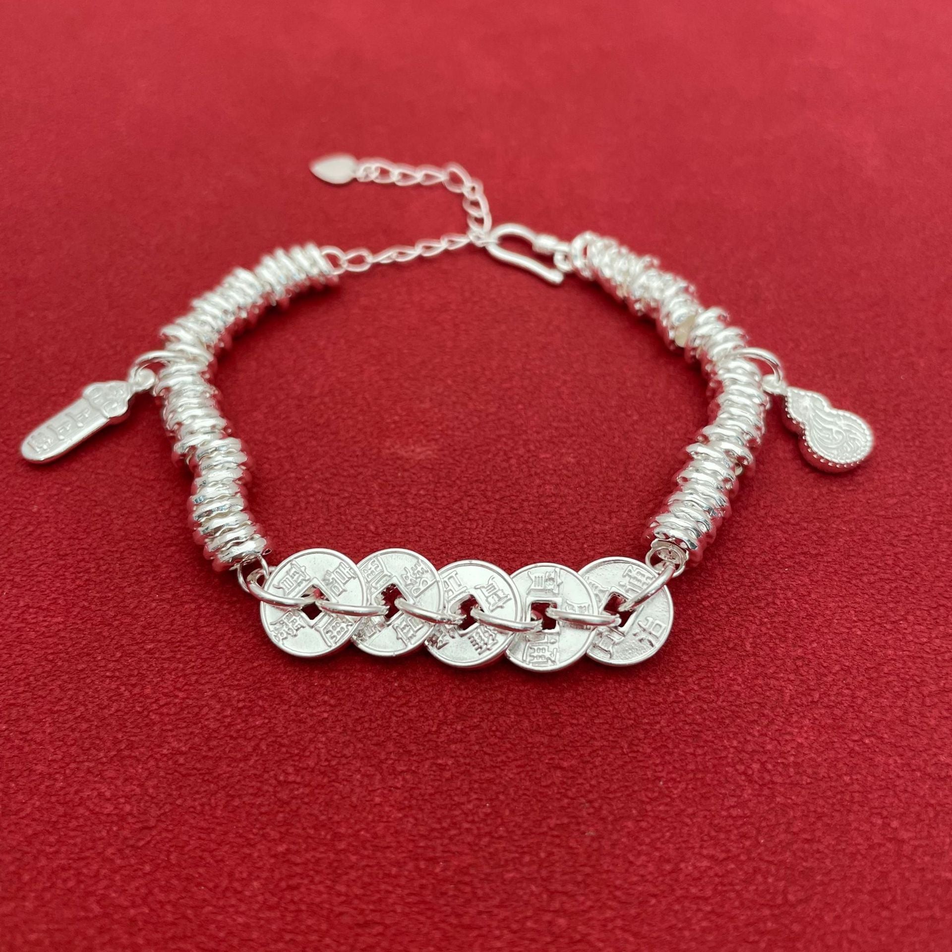 Sterling silver bracelet with five emperor coins, a traditional Chinese style, symbolizing good fortune, peace, joy, versatility, elegance, and Chinese aesthetics.