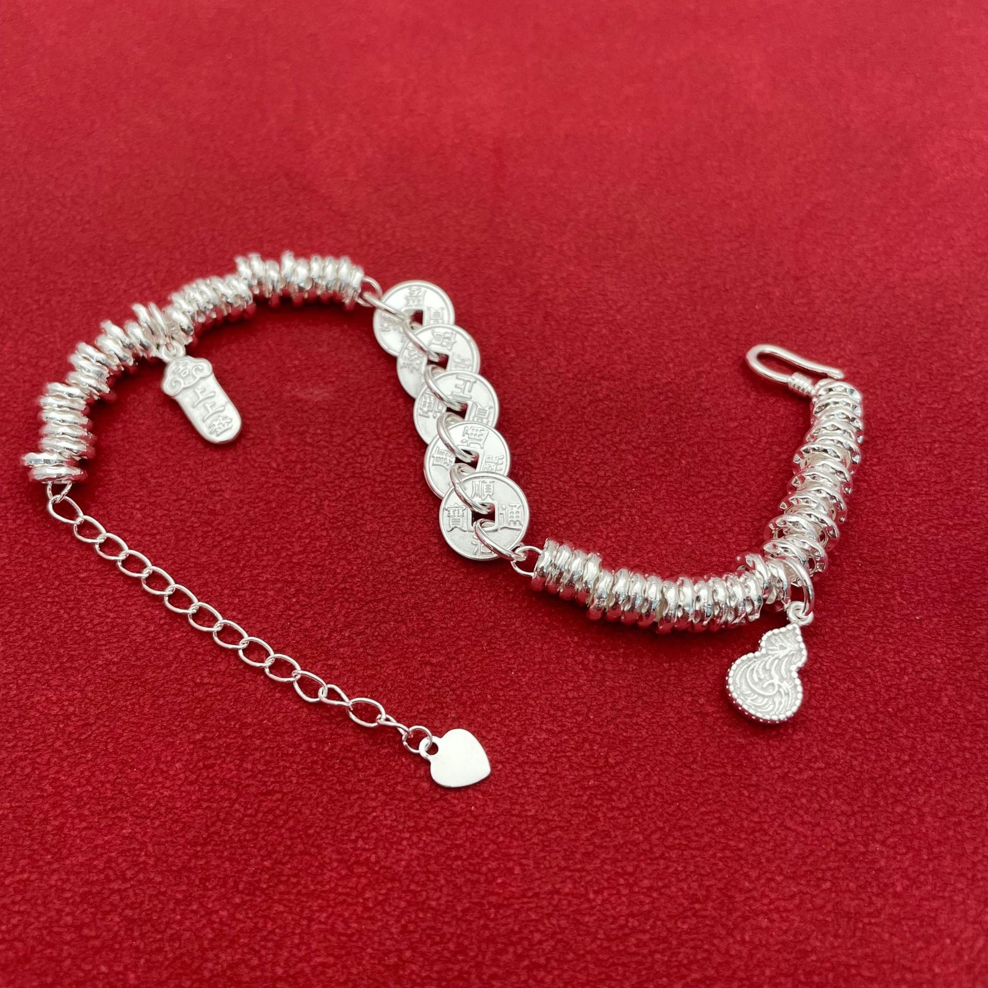 Sterling silver bracelet with five emperor coins, a traditional Chinese style, symbolizing good fortune, peace, joy, versatility, elegance, and Chinese aesthetics.