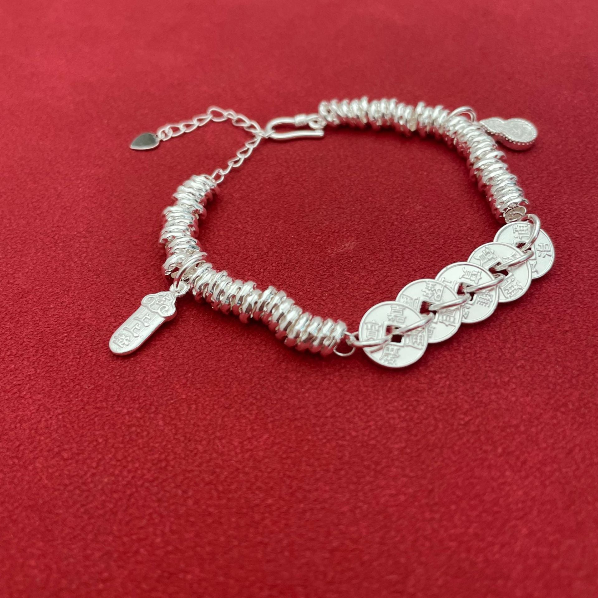 Sterling silver bracelet with five emperor coins, a traditional Chinese style, symbolizing good fortune, peace, joy, versatility, elegance, and Chinese aesthetics.