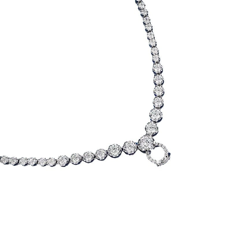 A versatile, high-end necklace with a full diamond clasp and a multi-purpose chain. It features a unique design and a sophisticated, understated style.