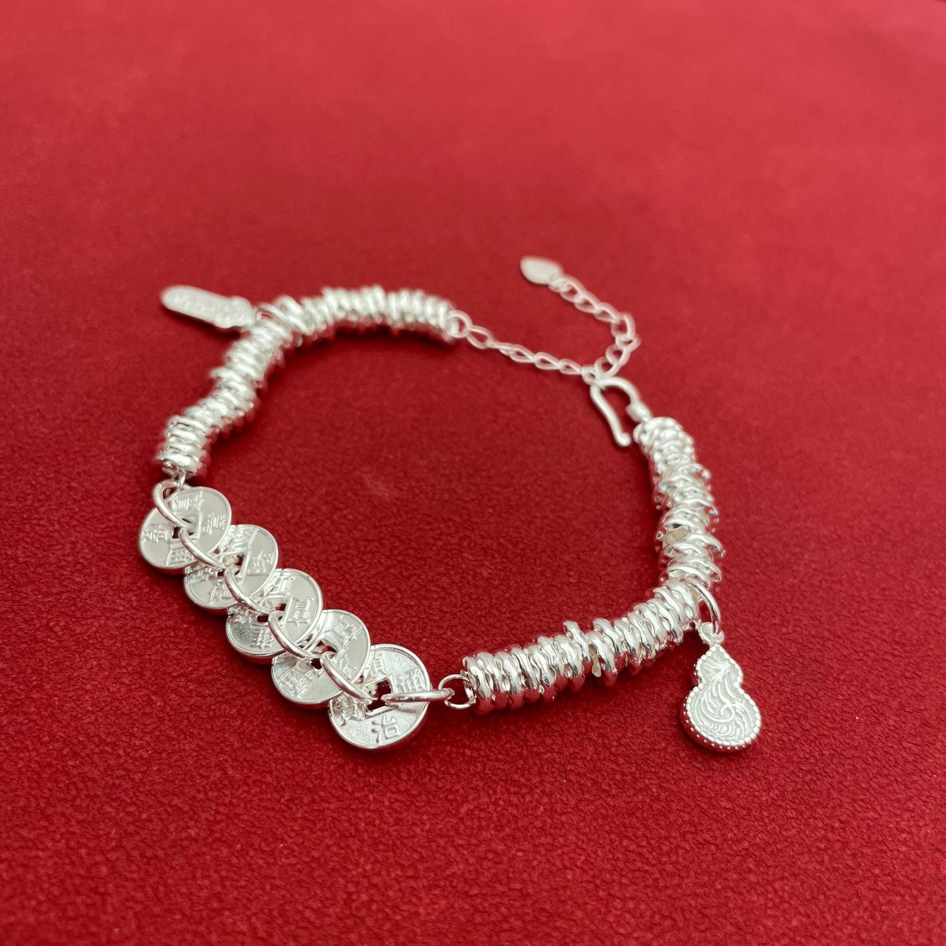 Sterling silver bracelet with five emperor coins, a traditional Chinese style, symbolizing good fortune, peace, joy, versatility, elegance, and Chinese aesthetics.